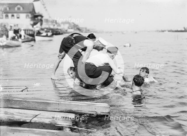 Untying Otto after 45 yd. swim - hands and feet tied, (1910?). Creator: Bain News Service.