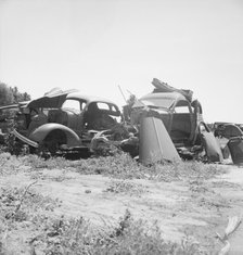 Used car lots and auto wrecking establishments, U.S. 99,  Near Tulare, California, 1939. Creator: Dorothea Lange.