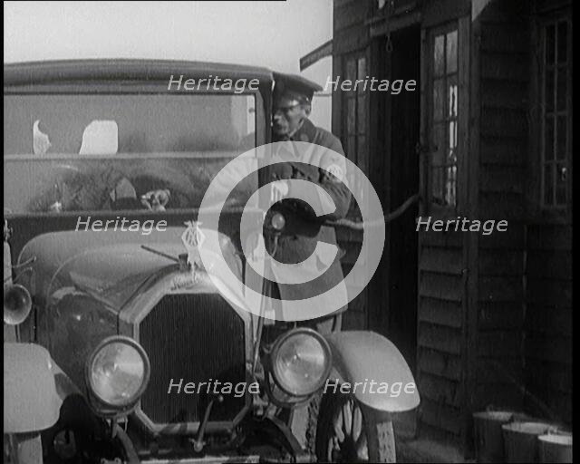 A British Automobile Association Employee Filling a Car With Petrol at the First Petrol Station,1920 Creator: British Pathe Ltd.