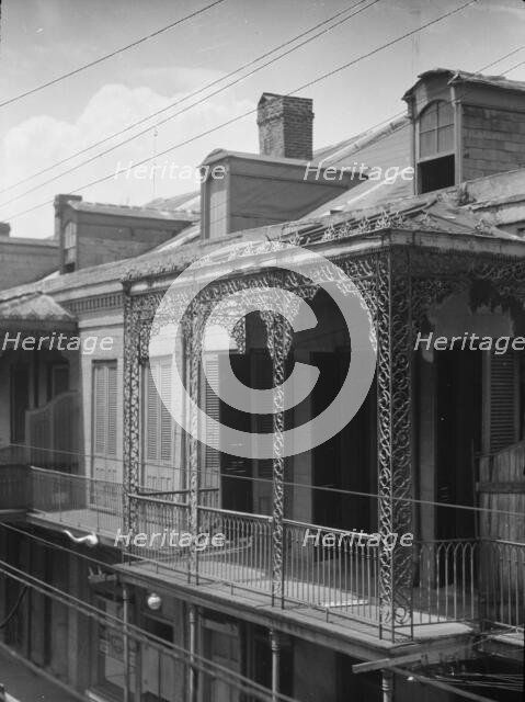Upper story of building with wrought iron balconies, New Orleans, between 1920 and 1926. Creator: Arnold Genthe.