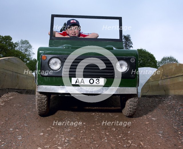 Children driving a toy Land Rover. Artist: Unknown.