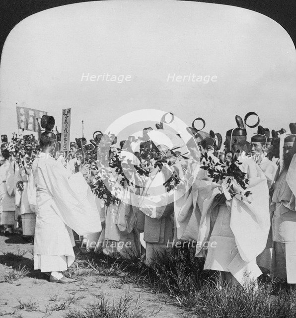 Shinto priests in a funeral procession for 'Hitachi Maru' victims, Tokyo, Japan, 1905. Artist: HC White