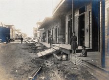 Colón, Panama: unpaved street lined with wooden houses; two children watch from a porch..., 1906. Creator: Unknown.