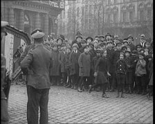 British Soldiers Standing by a Tank in a German Town as Civilians Look On, 1921. Creator: British Pathe Ltd.