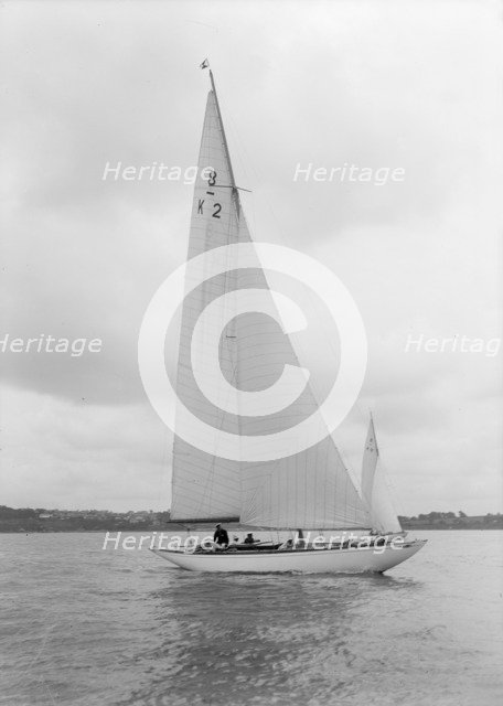 The 8 Metre Carron (K2) sailing upwind, 1934. Creator: Kirk & Sons of Cowes.