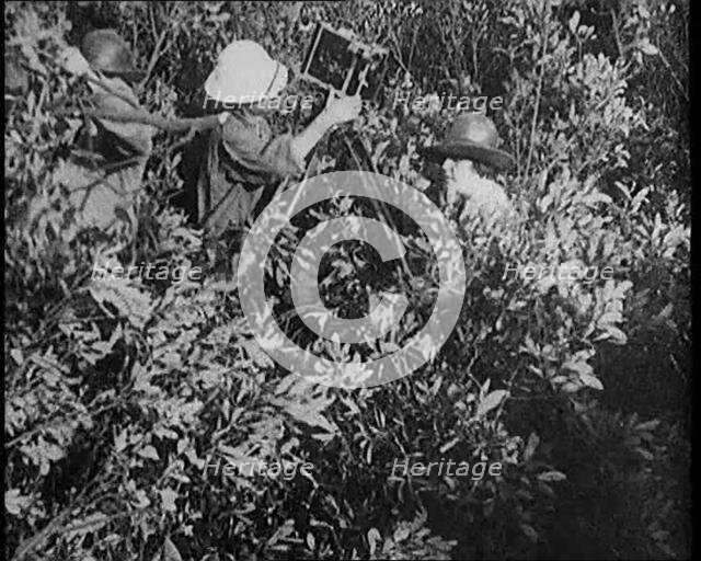 Female Civilians Wearing Explorers Outfit Setting up a Camera to Record Nature Life in the..., 1920. Creator: British Pathe Ltd.