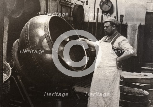 A man in an apron panning chocolate, Rowntree Cocoa Works, York, Yorkshire, 1900. Artist: Unknown
