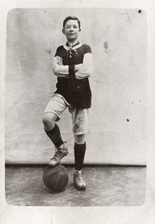 A boy poses in football kit, 1910. Artist: Unknown