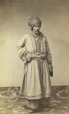George Kennan, full-length portrait in traditional costume of unidentified..., between 1870 and 86. Creator: Unknown.