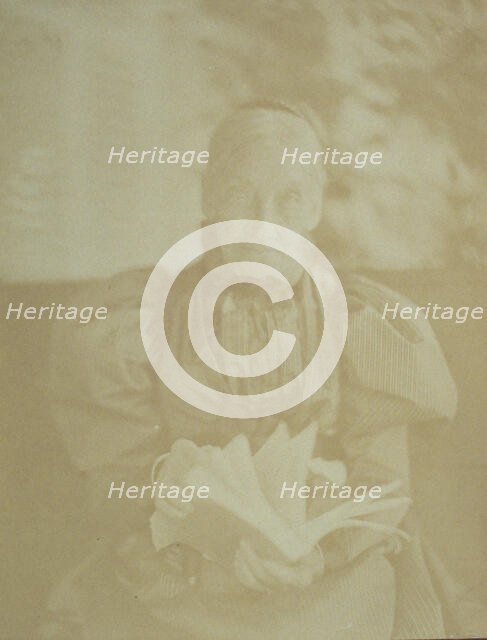 Elderly woman sitting in a chair holding a book, half-length portrait, facing front, c1890. Creator: Horace L Bundy.
