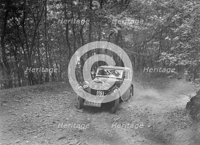 Singer coupe competing in the B&HMC Brighton-Beer Trial, Fingle Bridge Hill, Devon, 1934. Artist: Bill Brunell.