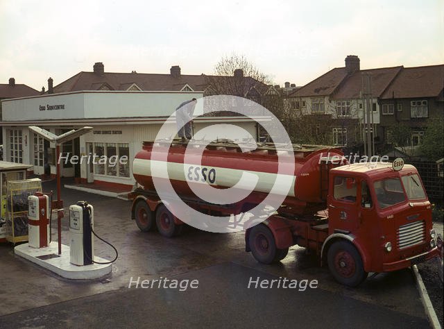 Ilford Esso petrol station with Leyland tanker making delivery 1964. Creator: Unknown.