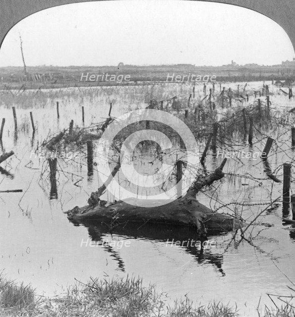 Opened sluices and barbed wire at Nieuwpoort, Belgium, World War I, c1914-c1918. Artist: Realistic Travels Publishers