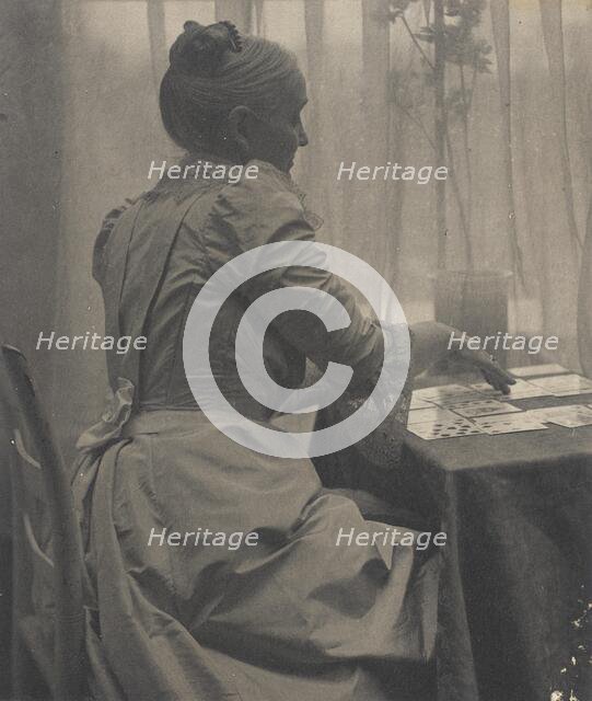 Woman Playing Solitaire, c.1910. Creator: Gertrude Kasebier.