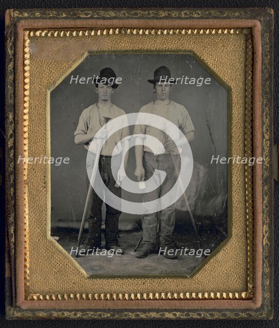 Occupational portrait of two men, standing full length holding floor rammers..., ca. 1850. Creator: Unknown.