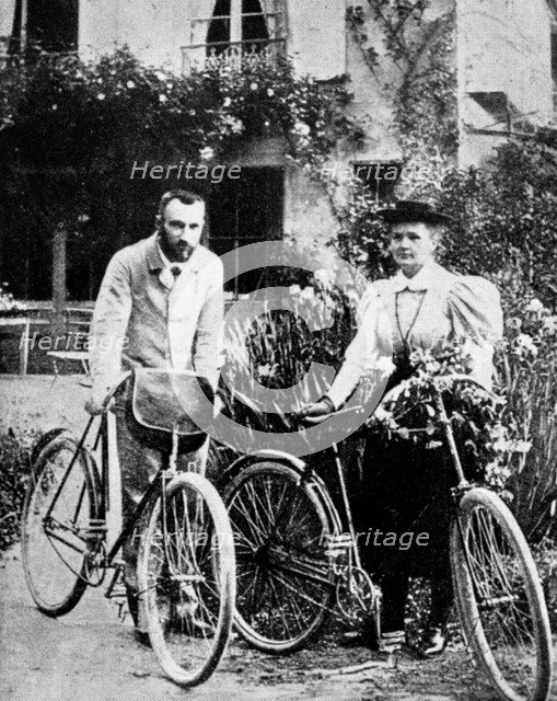 Pierre and Marie Curie, French physicists, preparing to go cycling. Artist: Unknown