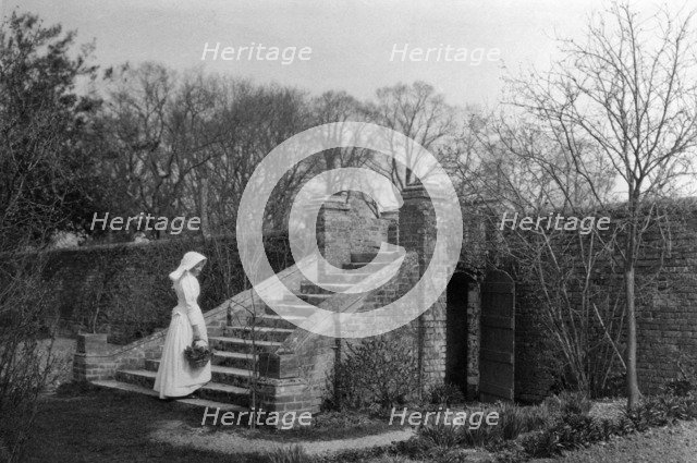 Woman standing at the base of the garden steps, Ufton Court, Ufton Nervet, Berkshire. c1901. Artist: Maxwell-Lyte.