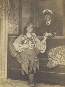 A sailor holds hands with a man in elaborate drag, [between 1910 and 1999?]. Creator: Unknown.