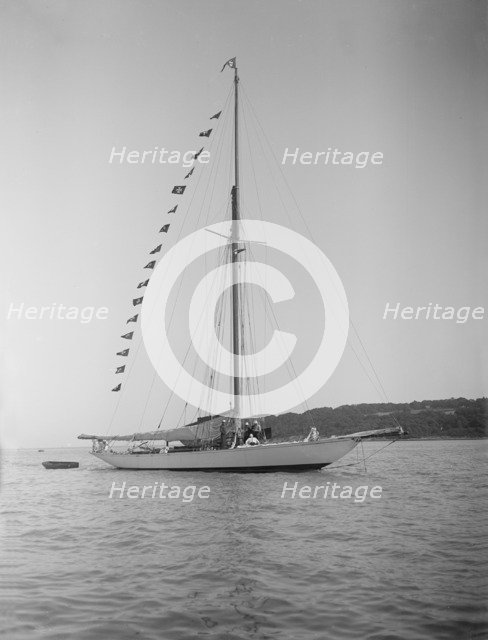 The 40-rater cutter 'Carina' at anchor with flags, 1911. Creator: Kirk & Sons of Cowes.