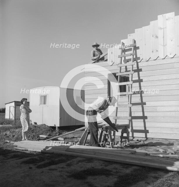 Father and son building house on outskirts of Salinas, California, 1939. Creator: Dorothea Lange.