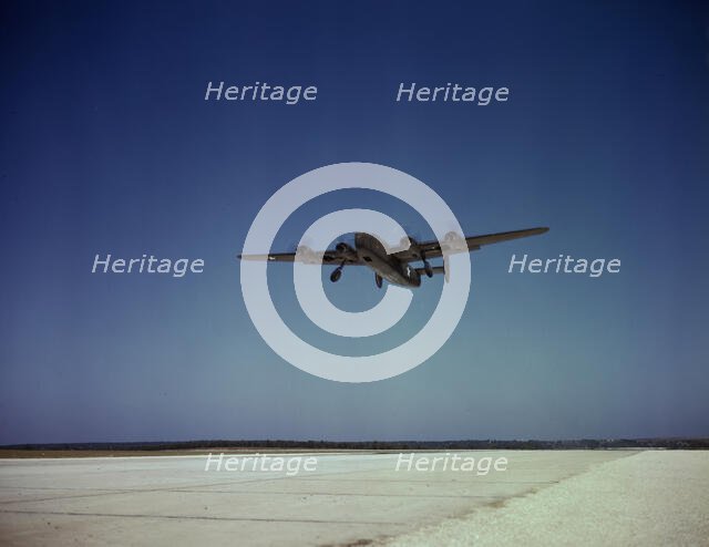 Transport plane takes off on test flight, Consolidated Aircraft Corp., Fort Worth, Texas, 1942. Creator: Howard Hollem.