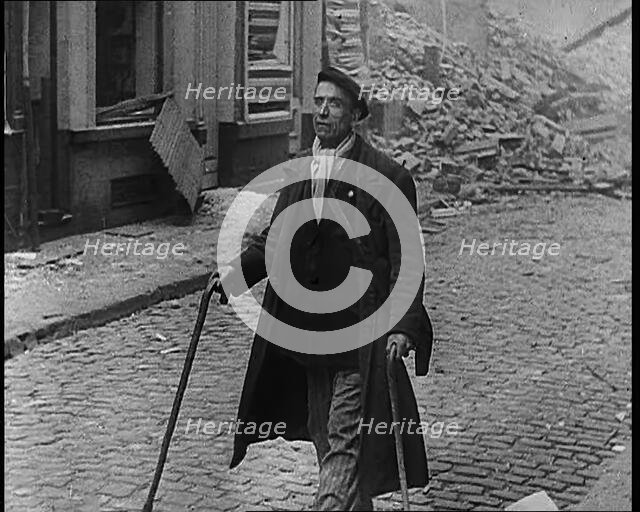 French Refugee Walking Through Demolished Town, 1940. Creator: British Pathe Ltd.