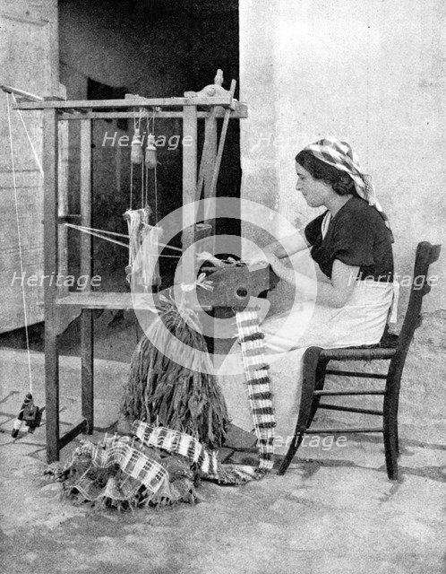 Woman weaving with straw on a hand loom, Fiesole, near Florence, Italy, 1936. Artist: Donald McLeish