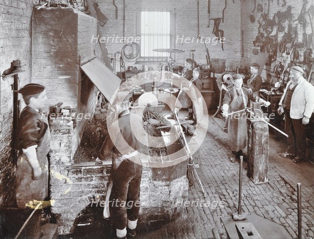 Boys at work in the smith's shop, Feltham Industrial School, London, 1908. Artist: Unknown.