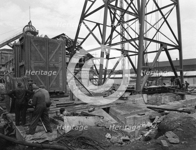 Installing a cage at Hickleton Main pit, Thurnscoe, South Yorkshire, 1961. Artist: Michael Walters