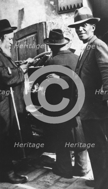 Examining tzitzit, Lemberg Ghetto, USSR, 1941-1944. Artist: Unknown