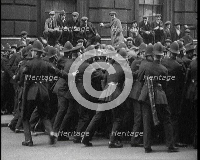British Police Officers Holding Back Crowds of Demonstrators in Downing Street, London, 1920. Creator: British Pathe Ltd.