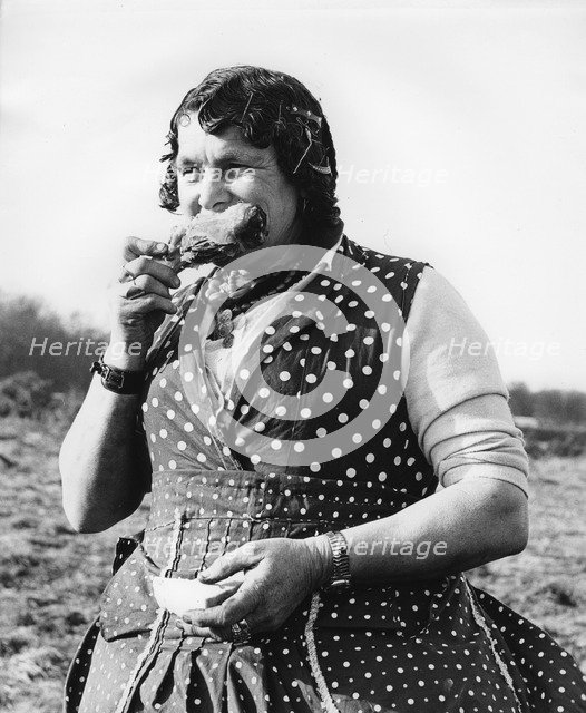Gypsy woman eating, 1960s.