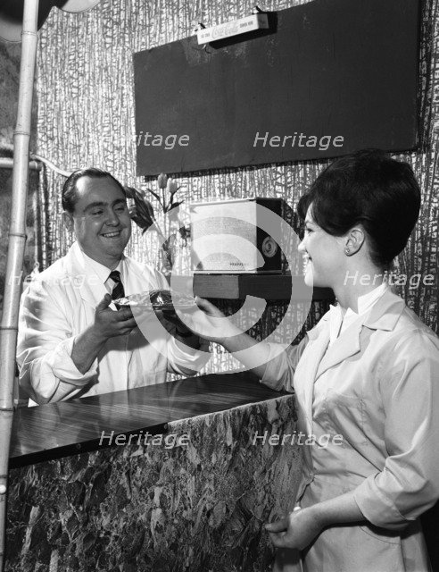 Serving a meal to a customer in a cafe, Mexborough, South Yorkshire, 1964. Artist: Michael Walters