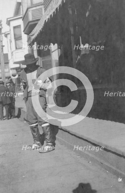 Man outside store, between c1900 and 1916. Creator: Unknown.