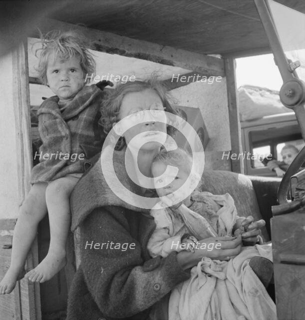 Mother and two children on the road, Tulelake, Siskiyou County, California, 1939. Creator: Dorothea Lange.