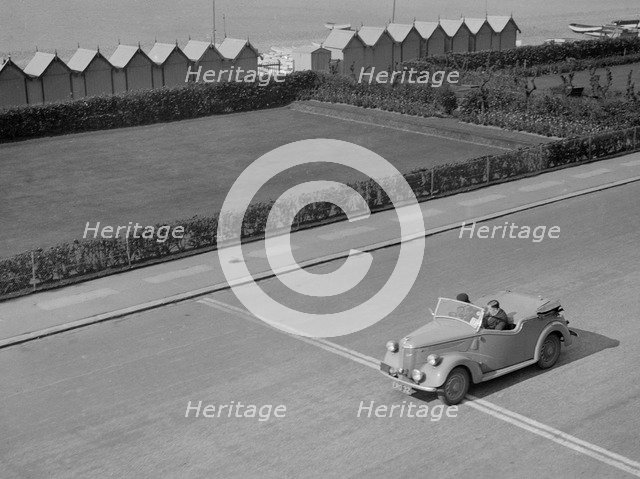 Ford Prefect tourer of JW Whalley competing in the RAC Rally, Madeira Drive, Brighton, 1939. Artist: Bill Brunell.