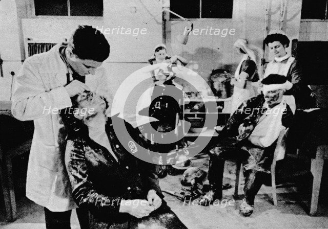 'Behind The Lines Were Many Workers. With the blitz still at its height, casualties are attended to  Artist: Unknown.