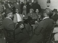 African Americans conversing and drinking beers in a bar, Clarksdale, Mississippi Delta, Nov 1939. Creators: Farm Security Administration, Marion Post Wolcott.