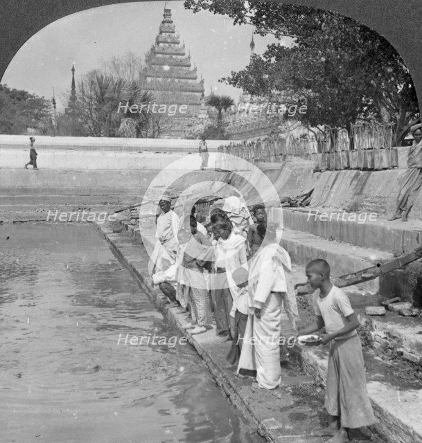 Pilgrims feeding holy turtles, Arakan Pagoda, Mandalay, Burma, 1908.  Artist: Stereo Travel Co