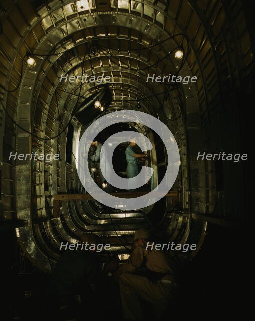 Installing structural parts of a C-87 transport...Consolidated Aircraft..., Fort Worth, Texas, 1942. Creator: Howard Hollem.