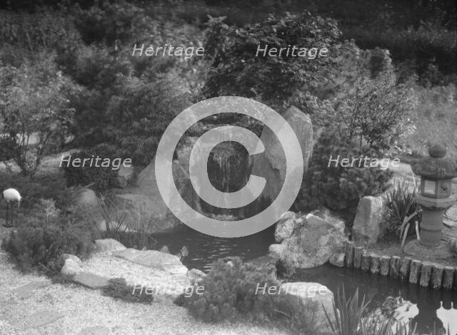 Garden with a Japanese waterfall and a stone lantern, possibly belonging to A.W. Bahr, c1917-1934. Creator: Arnold Genthe.