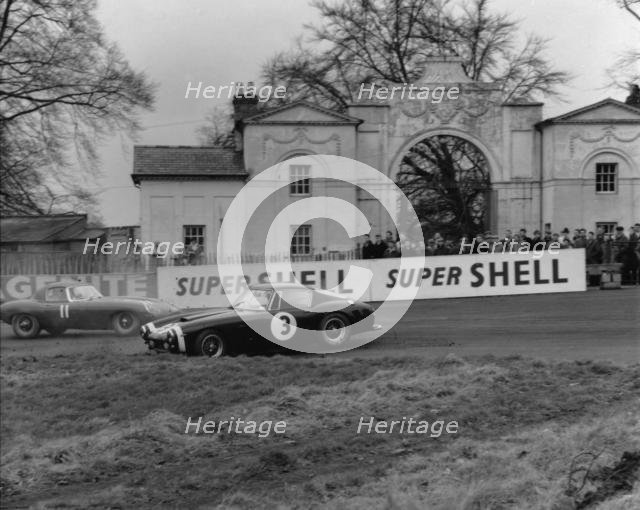 Ferrari 250 SWB spins as Jaguar E type passes. Creator: Unknown.