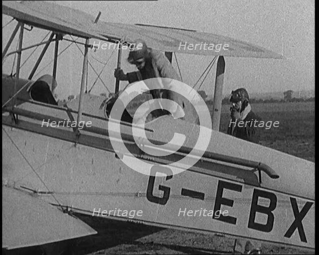 American Aviator Amelia Mary Earhart Wearing a Helmet Boarding an Airplane, 1920. Creator: British Pathe Ltd.