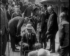 King George V of the United Kingdom Sitting On a Model Train With a Crowd of People Watching, 1924. Creator: British Pathe Ltd.