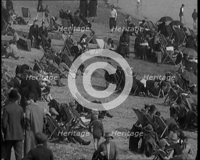 A Crowd of Civilians Sitting on Deckchairs at the Beach, 1926. Creator: British Pathe Ltd.