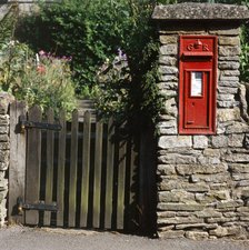 Wall-mounted post box and wooden gate, Upper Slaughter, Cotswolds, Gloucestershire, c2000s(?). Artist: Unknown.