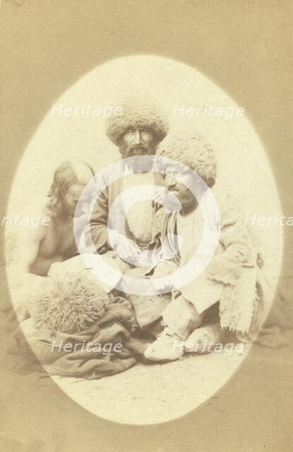 Full-length portrait of three men, seated on ground, facing front, between 1870 and 1886. Creator: Unknown.