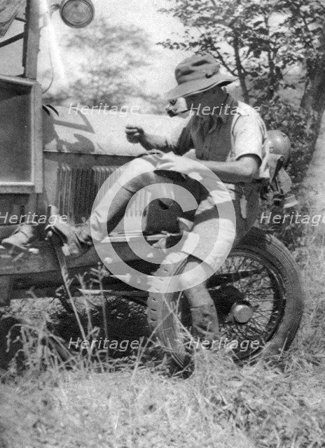 Chaplin Court Treatt, British motoring pioneer, mending his veldtschoen (shoes), c1924-c1926 (1927). Artist: Thomas A Glover