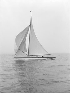 The 6 Metre class 'Marmi' sailing under spinnaker, 1914. Creator: Kirk & Sons of Cowes.