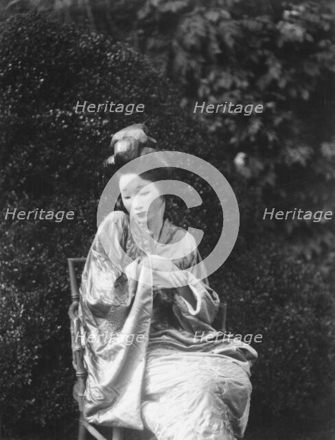 Person wearing a mask made by W.T. Benda, 1925 Sept. 20. Creator: Arnold Genthe.